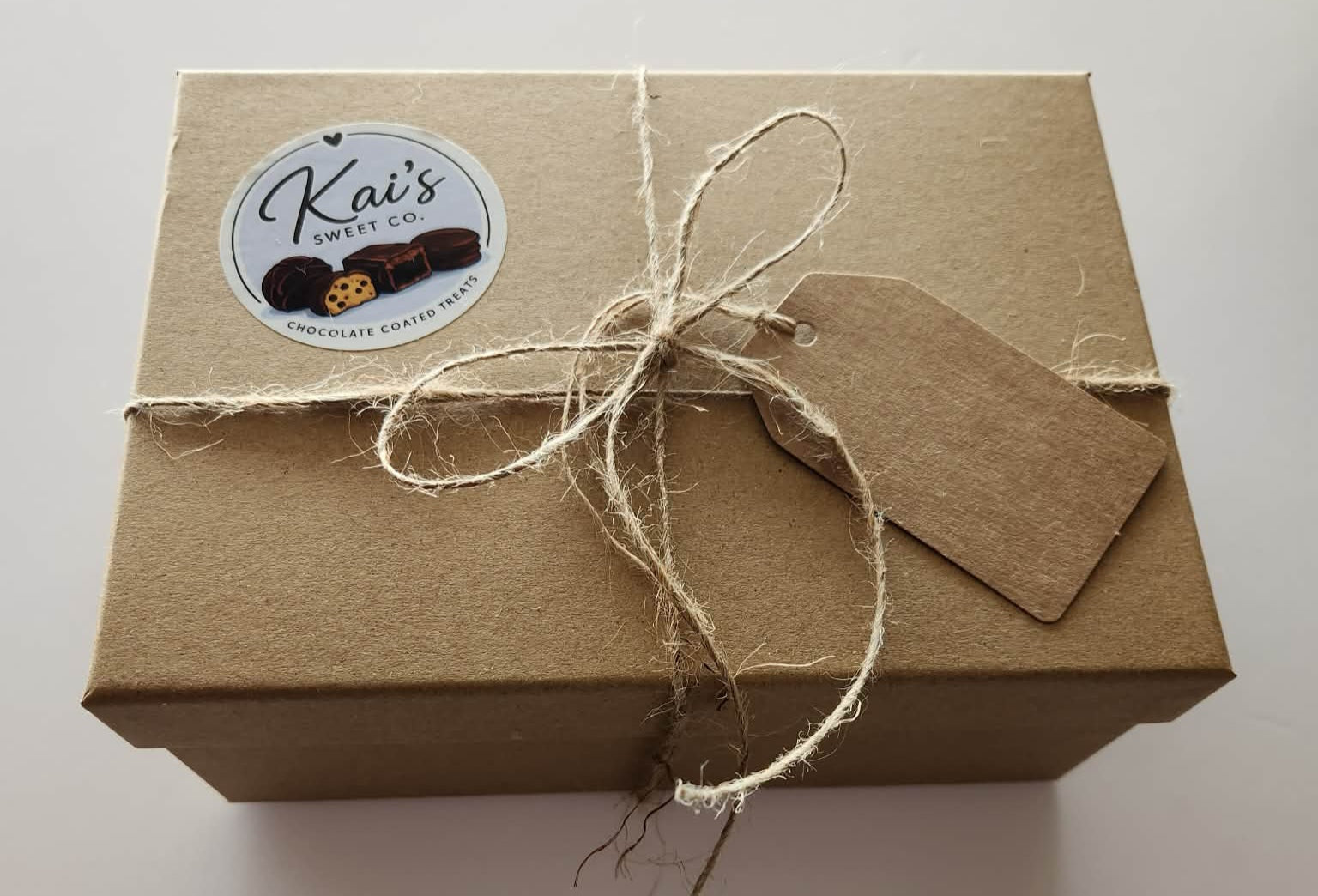 Kai's Sweet Co Small Gift Box closed with kraft box, twine tie and Kai's Sweet Co logo gift tag
