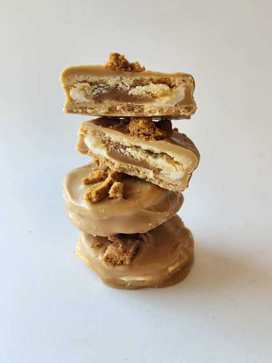 Kai's Sweet Co Biscoff Mini Roundabouts stacked and cut open showing Biscoff biscuit and marshmallow filling, Biscoff chocolate coated