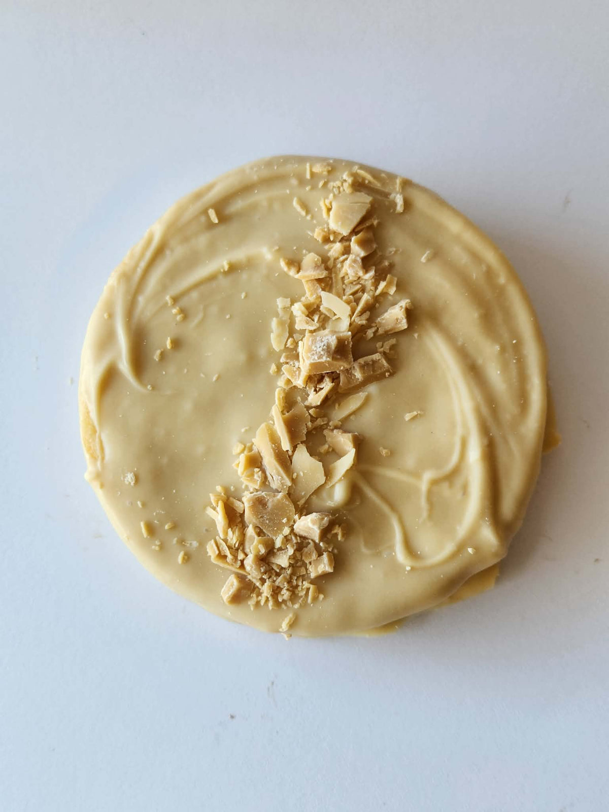 Kai's Sweet Co Caramilk Roundabout top down view, Caramilk white chocolate coated with Caramilk chunk topping, handmade sweet treat
