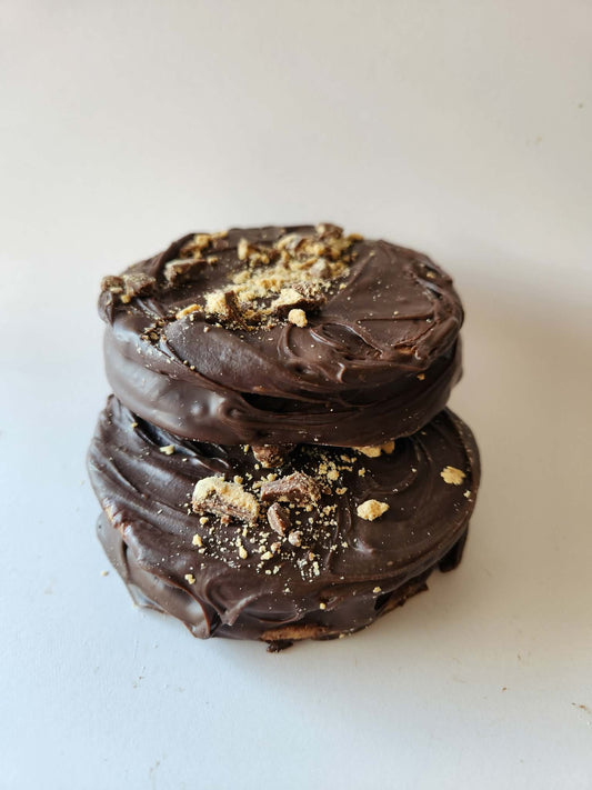 Kai's Sweet Co Peanut Butter Roundabout two stacked, milk chocolate coated with peanut butter crumble topping