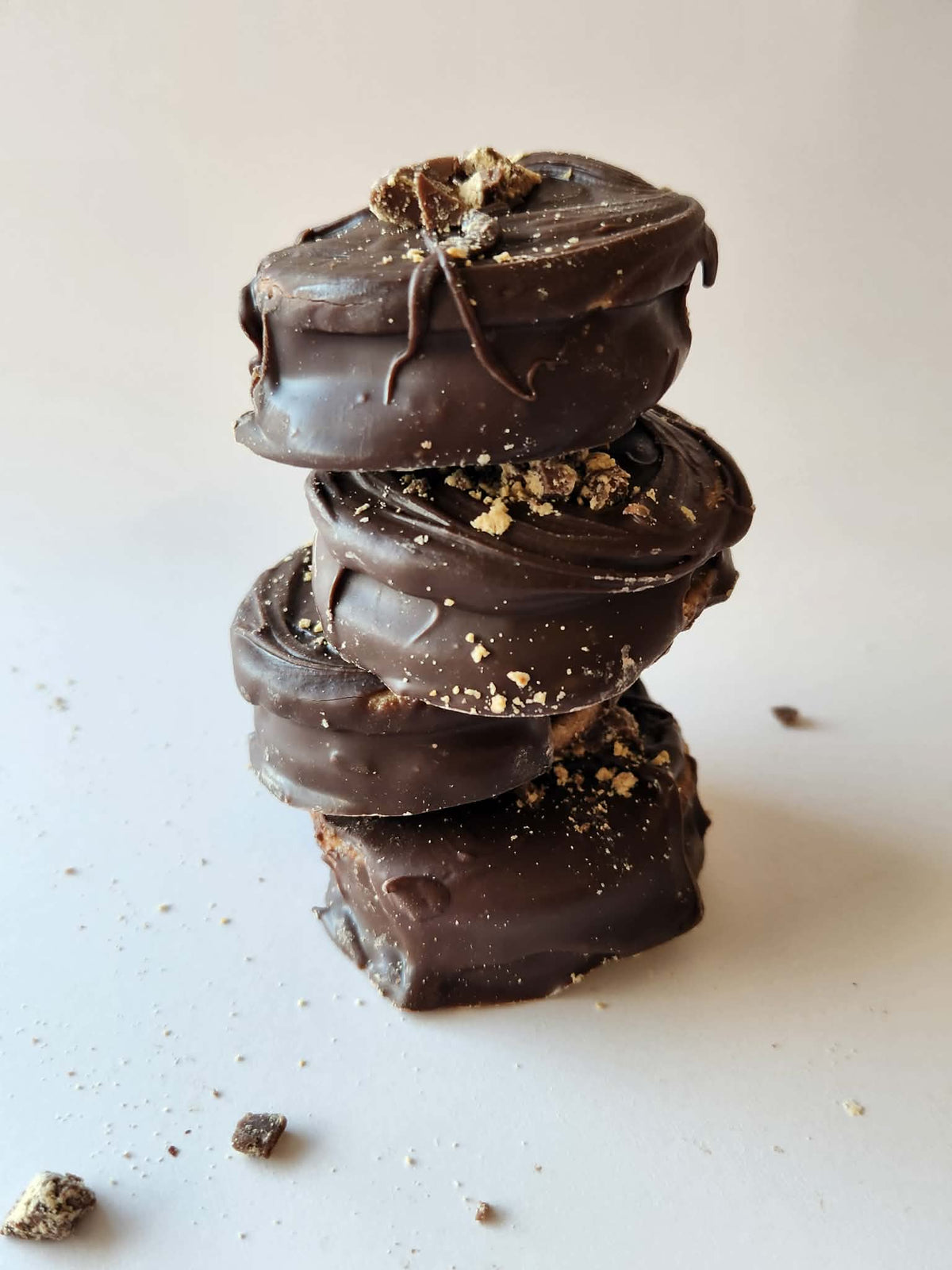 Kai's Sweet Co Peanut Butter Mini Roundabouts stacked four high with peanut butter crumble topping, chocolate coated handmade treats