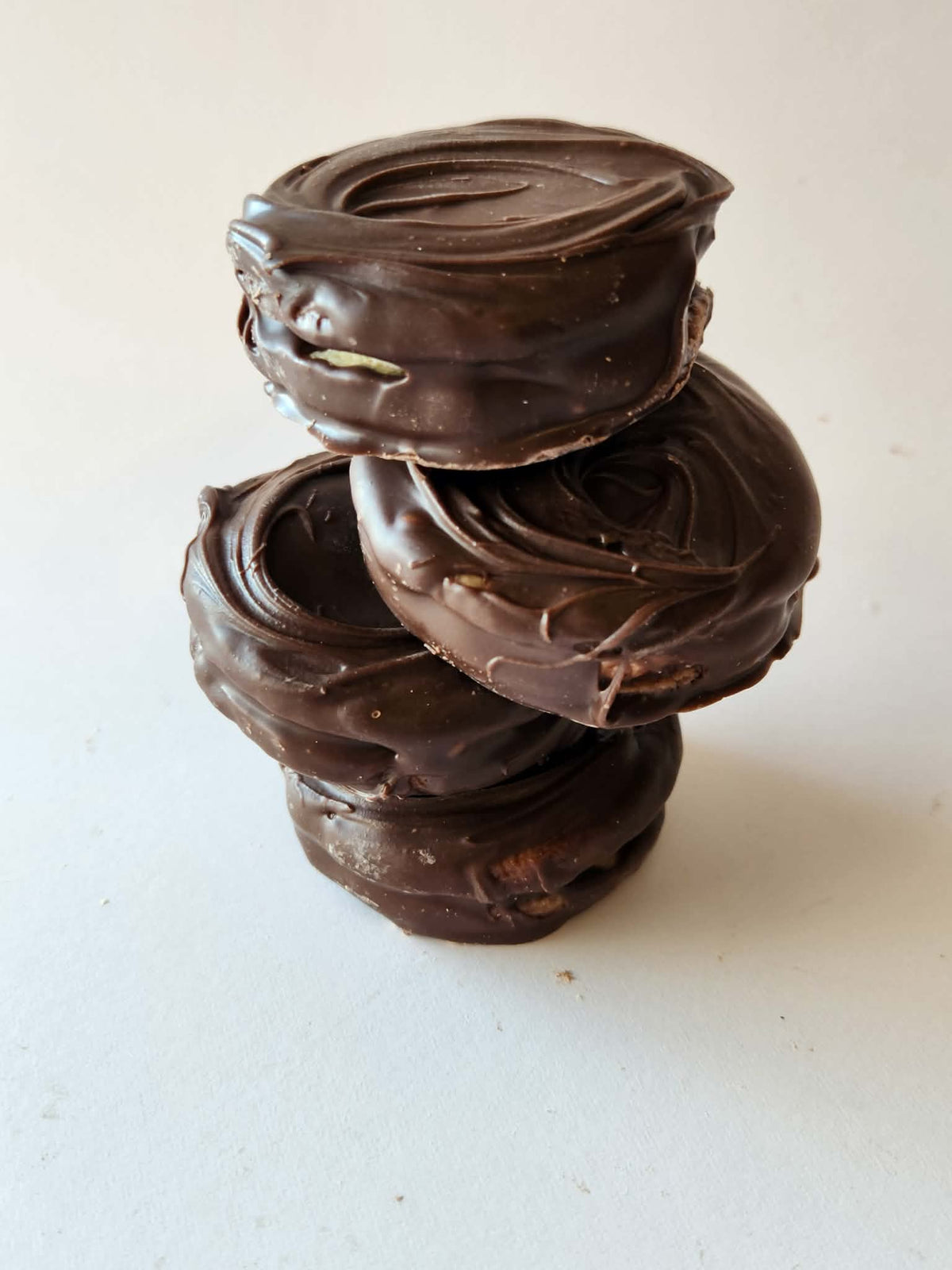 Kai's Sweet Co Raspberry Jam Mini Roundabouts stacked three high, dark chocolate coated handmade treats