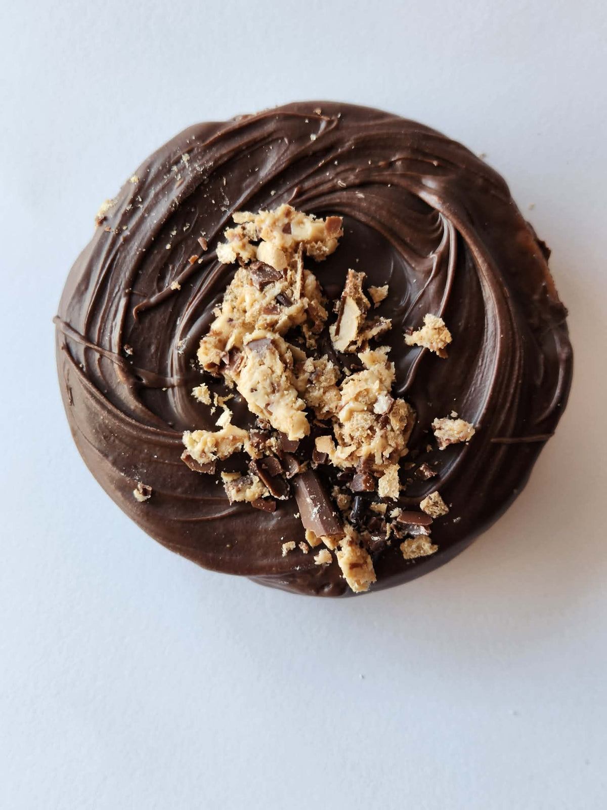 Kai's Sweet Co Kinder Bueno Roundabout top down view, dark chocolate coated with Kinder Bueno wafer crumble topping, handmade sweet treat